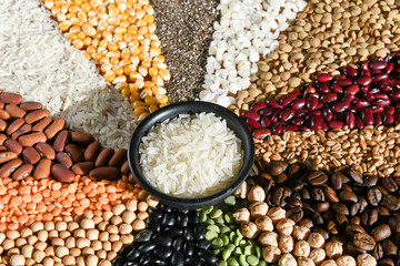 Bowl with raw white rices on various seeds grain