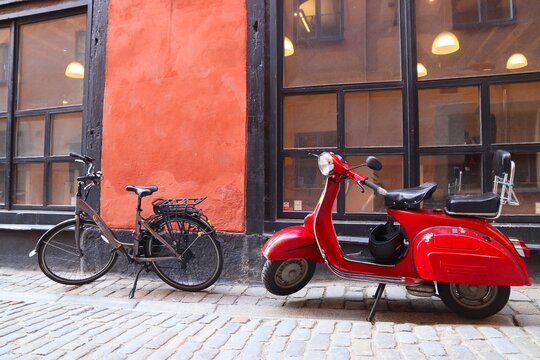 STOCKHOLM, SWEDEN - AUGUST 23, 2018: Piaggio Vespa retro scooter parked in narrow street of Gamla Stan (Old Town) in Stockholm, Sweden.