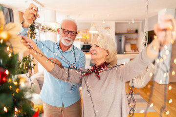 Senior couple decorating home for Christmas