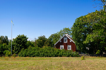 Red wooden house in the village Dörby, island of Öland, Sweden