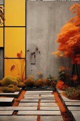 Plants and trees in autumn colors in a secluded concrete clad Japanese style garden. High walled area in urban environment. 