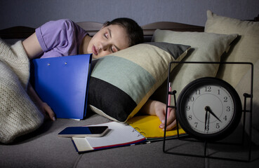 Fototapeta premium girl student fell asleep while doing homework