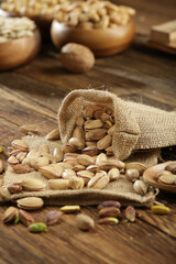 DRİED NUTS AND FRUİTS IN WOODEN BOWL ON BROWN FLOOR