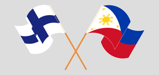 Crossed and waving flags of Finland and the Philippines