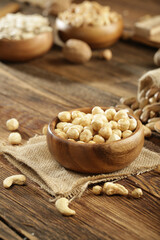 DRİED NUTS AND FRUİTS IN WOODEN BOWL ON BROWN FLOOR