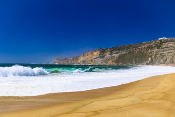 Fototapeta na wymiar Nazare beach in Portugal, home of oonw of the biggest waves in the world. Nazare bi waves beach