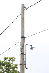 high-voltage electricity pylons against a white sky background