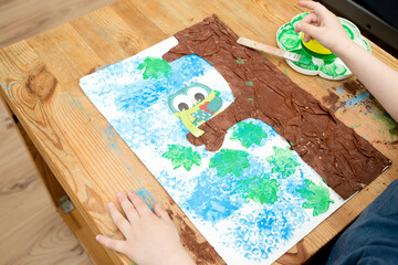 Kid draws a gouache spring tree. Children activities, easy ideas at home. Art lessons spring theme....