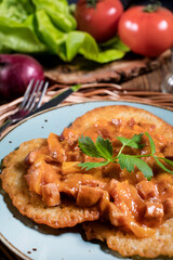 Homemade potato pancakes with goulash.