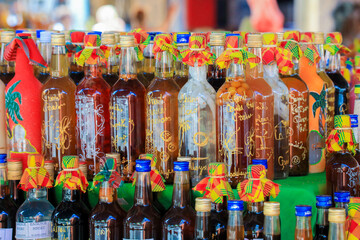 Colorful Gift Souvenir Bottles with the different Drinks on the Local Market, Guadeloupe