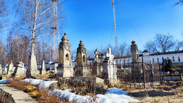 Sovetsk, Russia - April 03, 2023: Cemetery with old tombstones on a sunny day in spring. Image with selective focus