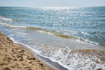 Beautiful seashore with surf. Seascape. The bottom is made of sand
