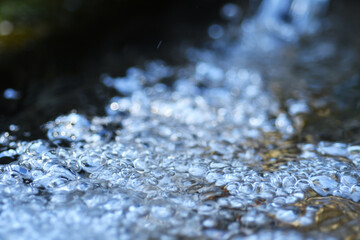 beautiful water bubbles  in natural spring water with nice sparkling bokeh. close up
