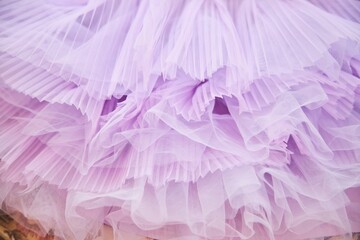 Pink tulle fabric. Flounces on a children's dress. Tailoring of fashionable clothes