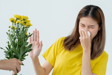 Pollen Allergies, asian young woman sneezing in a handkerchief or blowing in a wipe, allergic to...