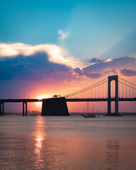 Fototapeta na wymiar Beautiful view of the Throgs Neck Bridge seen from Bayside Queens looking towards the Bronx, New York City seen during colorful sunset.