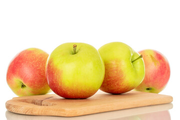 Several sweet juicy apples on a wooden kitchen board, macro, isolated on white background.