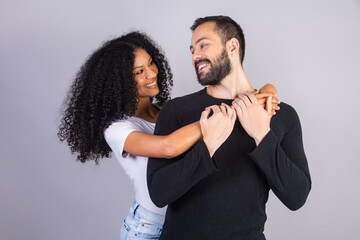 Interracial couple, Caucasian man and black woman, Brazilian. Lovers. Together. embraced.