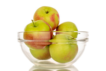 Several organic juicy apples in a glass plate, macro, isolated on white background.