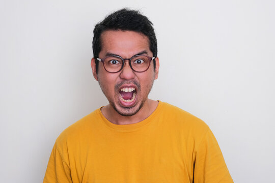 Closeup Portrait Of Adult Asian Man Screaming Mad