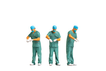 Miniature people Full length portrait of young doctor in scrubs Isolated on white background with...
