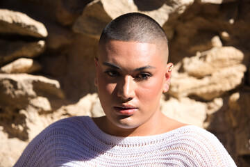 Non binary latin and young person, he is a professional make-up artist and he is showing off his make-up in the portrait making different expressions. Concept of diversity, homosexuality and gay pride