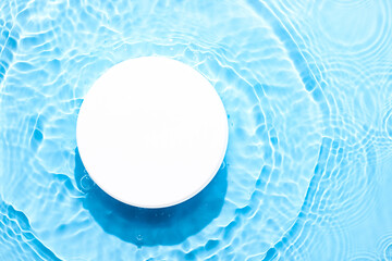 Water blue surface abstract background. Waves and ripples texture of cosmetic aqua moisturizer with...