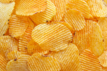 Potato chips or crisps texture background.  Crunchy fried potato slices.