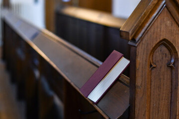 Old holy books and hymnals lying at the altar and in the church and on the pews in an old...