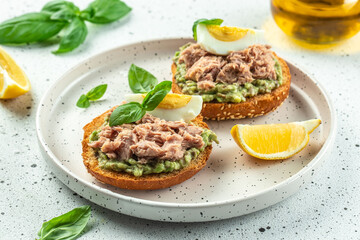 sandwiches with canned tuna, boiled egg and avocado. Food recipe background. Close up