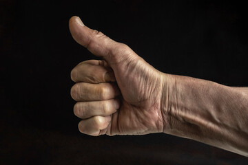 Man's Hand with Thumbs Up Gesture