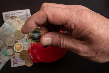 Hombre sujetando pesos colombianos en la mano