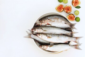 Mediterranean fish, Loban, Mullet, seafood, bowls on white background, top view, free space, place for text, background image, background for presentations