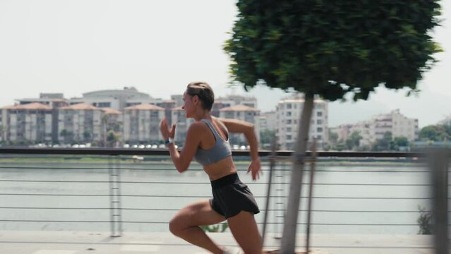 Young caucasian woman running in park sprinting exercising intense cardio workout. High quality 4k footage