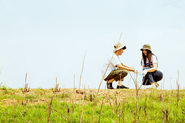 Asian couple looking at camera doing group recreational activities to do good for society together...