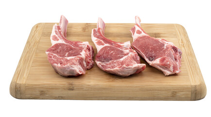 raw lamb steaks on a wooden board