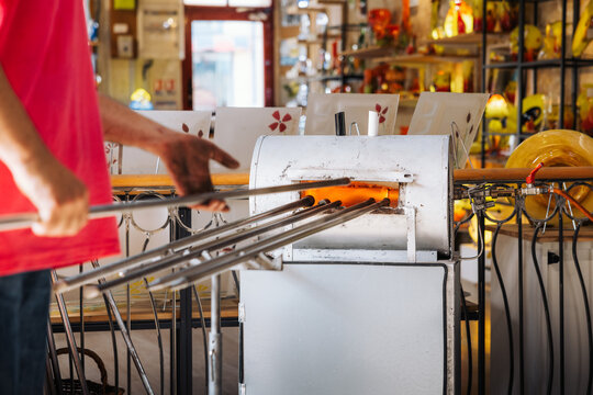 Glassblower crafting a Christmas bauble, from the heat of the oven to shaping it. Workshop based in France.