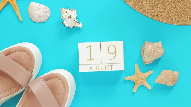 August. Wooden calendar on a blue background with summer accessories, top view. Vacation in summer. Perpetual calendar, boots, hat and shells with starfish. Alternate change of dates from 1 to 31