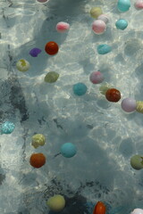 Floating plastic balls covered the swimming pool.