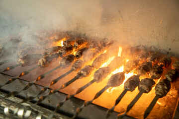 a kebab cooking in an outdoor smoking and fire