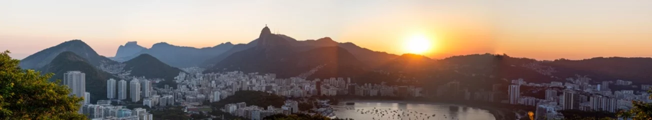 Foto auf Acrylglas Rio de Janeiro, Brazil: panoramic view at sunset from Sugarloaf Mountain with view of Humaitá district, the Christ the Redeemer on top of Mount Corcovado, Botafogo district and beach © Naeblys