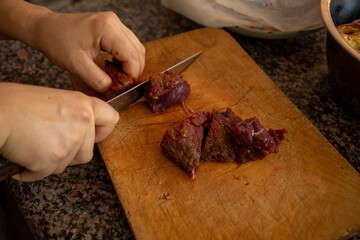  cutting the meat in a chopping board