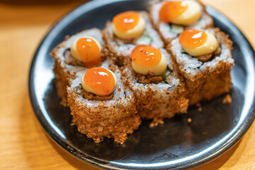 close up of sushi with chopsticks and soy