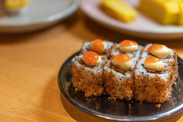 close up of sushi with chopsticks and soy