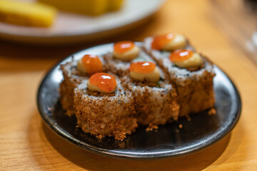 close up of sushi with chopsticks and soy