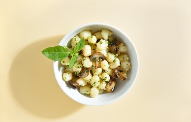 Potato gnocchi with mushroom, parmesan cheese and greens