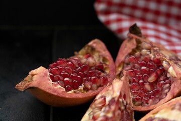 Fresh pomegranate halves on a rustic wooden table