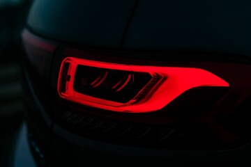 Closeup shot of an illuminated red tail light on a car