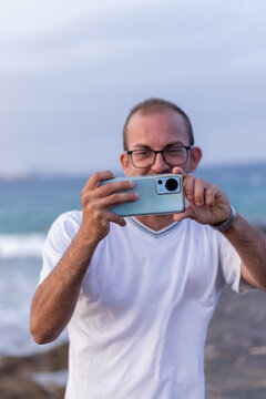 man taking photo with cell phone