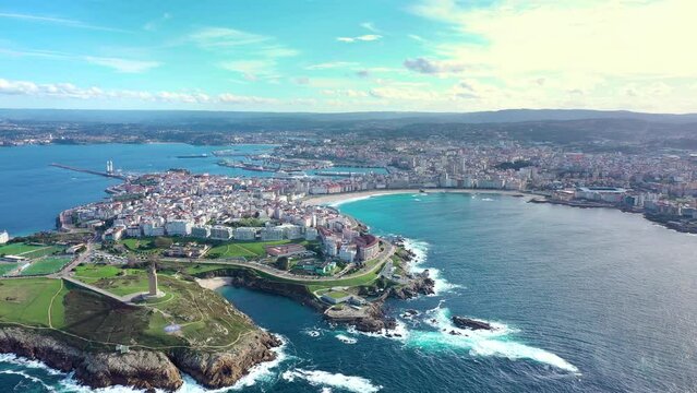 Cinematic panoramic view of A Coruna city, Galicia, Spain. Perspective from above of entire region. Riazor Beach and Orz&aacute;n beach. Drone backward. Travel destination and the richest region of Galicia